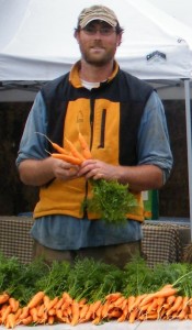 Farmer Brock washes fresh-picked carrots
