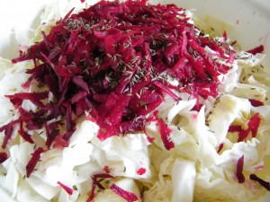 Sauerkraut prep: sliced cabbage, grated beets and caraway seeds.